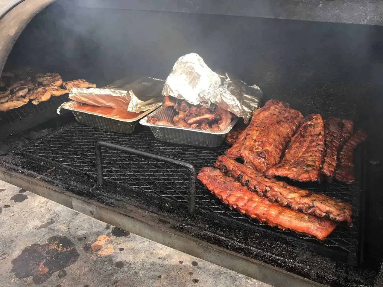 Pitmaster Jerry Willis tending the smoker at an Arizona BBQ catering event